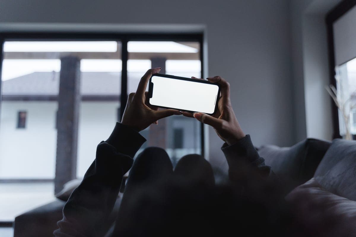 A phone app controlling smart lights and devices in a modern living room