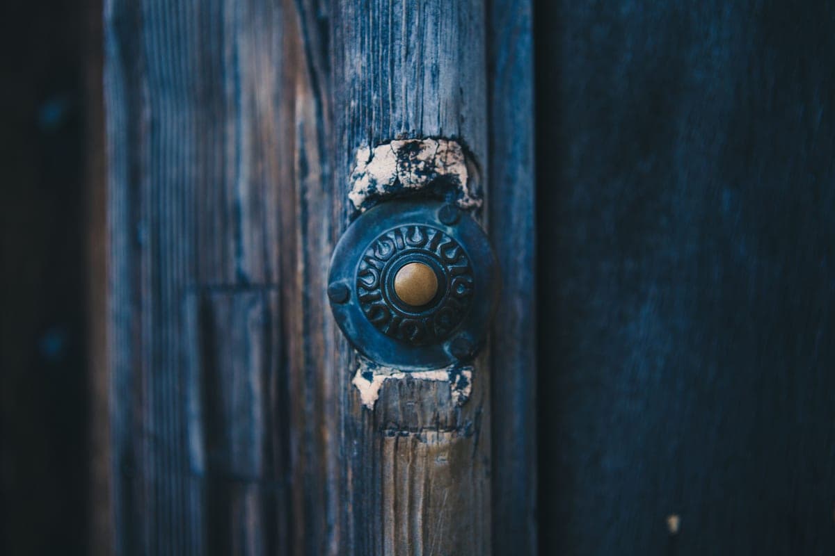 A video doorbell mounted beside a residential front door